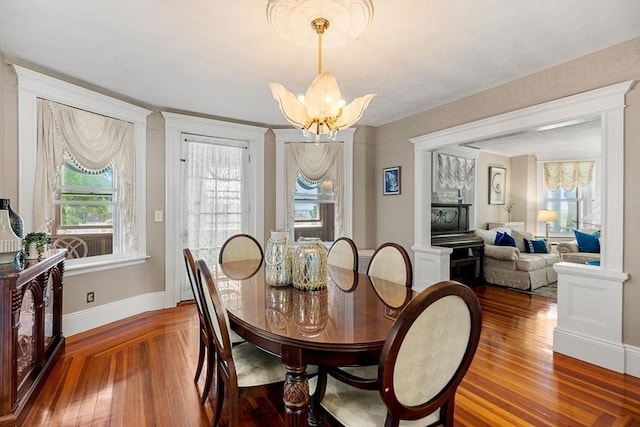 dining space with a notable chandelier and wood-type flooring