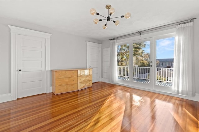 interior space featuring a notable chandelier and wood-type flooring