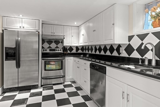 kitchen featuring backsplash, stainless steel appliances, sink, and white cabinets