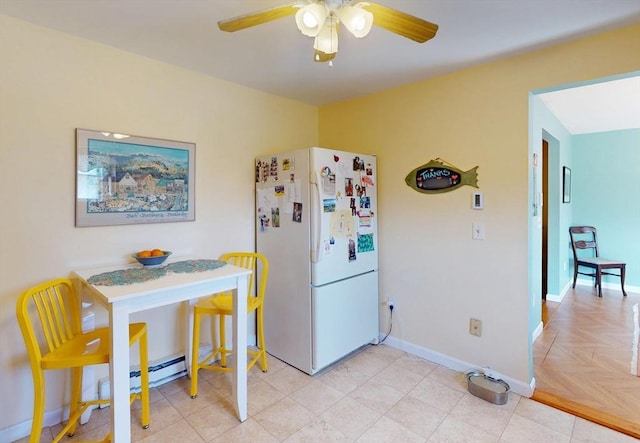 kitchen with freestanding refrigerator, a ceiling fan, and baseboards