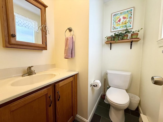 bathroom with tile patterned flooring, vanity, toilet, baseboards, and a baseboard heating unit