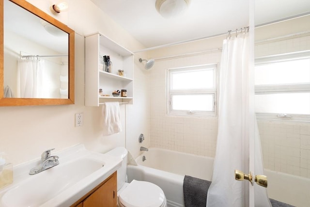 full bath with vanity, shower / tub combo, and toilet