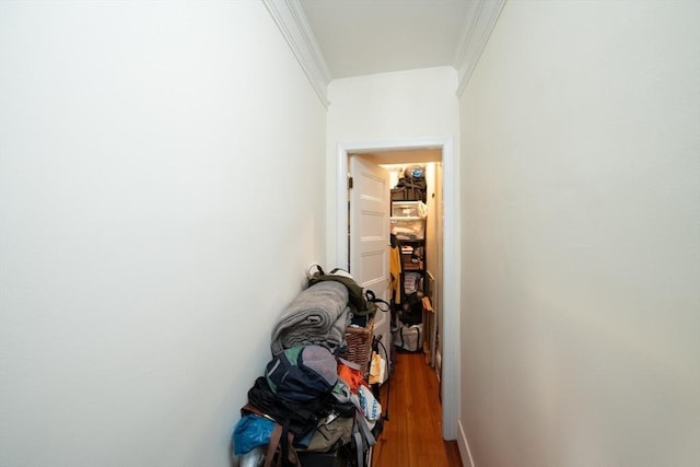 corridor with crown molding and wood finished floors