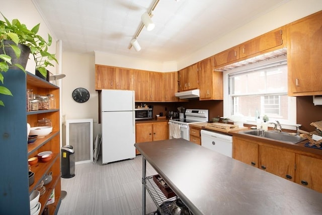 kitchen featuring a sink, white appliances, under cabinet range hood, and brown cabinets