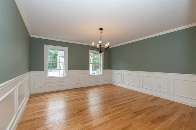 34 Torre St, Reading, MA 01867 - unfurnished room featuring a chandelier, crown molding, light wood-style flooring, and a wainscoted wall