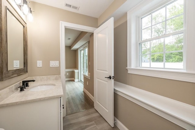 34 Torre St, Reading, MA 01867 - bathroom with vanity, healthy amount of natural light, and wood finished floors