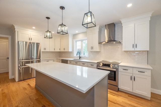 34 Torre St, Reading, MA 01867 - kitchen featuring stainless steel appliances, wall chimney range hood, light countertops, and recessed lighting