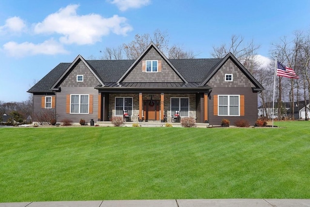 craftsman-style house featuring covered porch and a front lawn