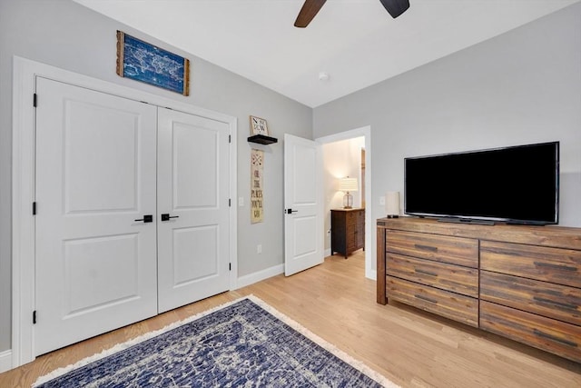 bedroom featuring light hardwood / wood-style flooring, a closet, and ceiling fan