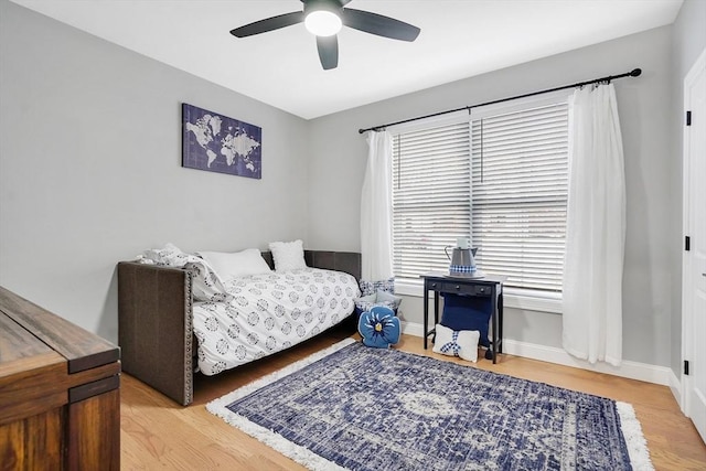 bedroom with ceiling fan and wood-type flooring