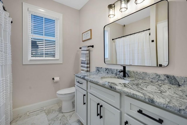 bathroom featuring vanity and toilet