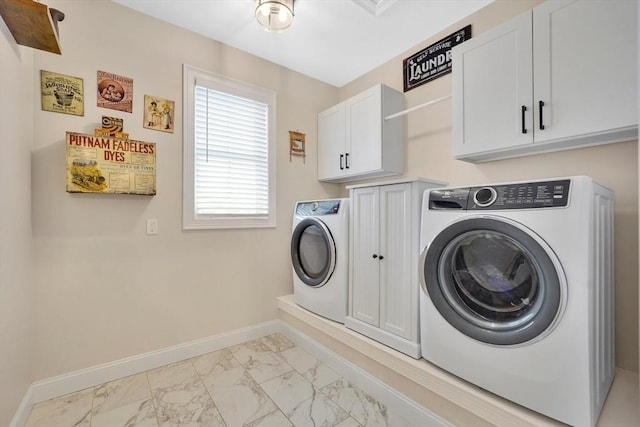 washroom with washer and clothes dryer and cabinets