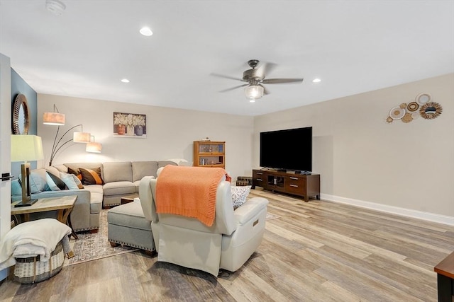 living room featuring ceiling fan and light wood-type flooring