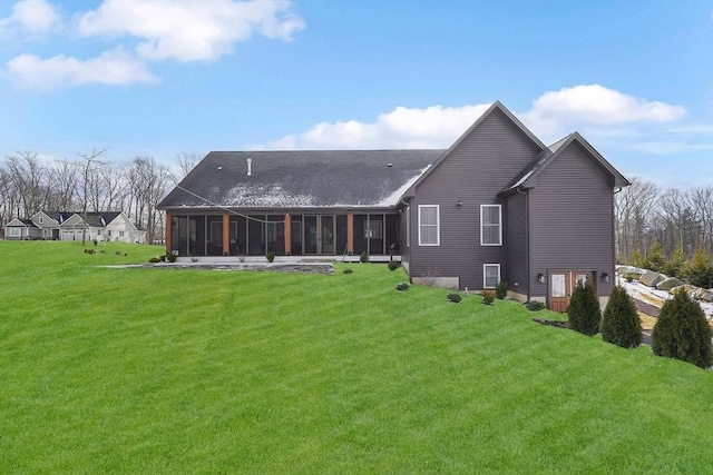 back of house with a sunroom and a yard