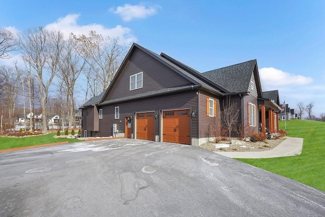 view of home's exterior featuring a garage and a lawn