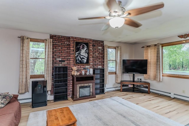 living room with a ceiling fan, baseboard heating, wood finished floors, and a fireplace