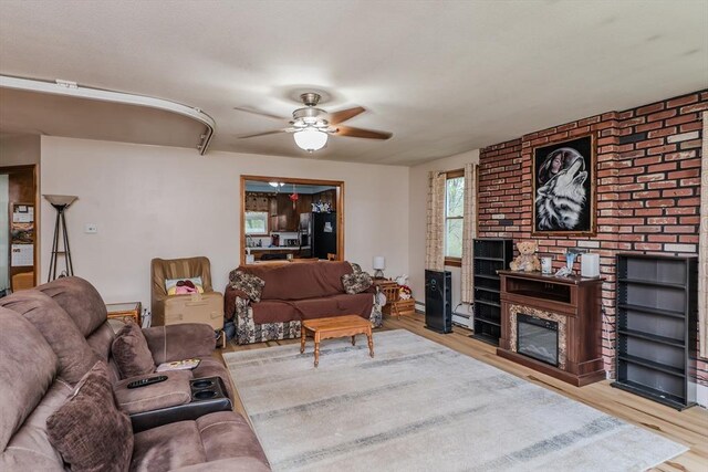 living room featuring ceiling fan and wood finished floors