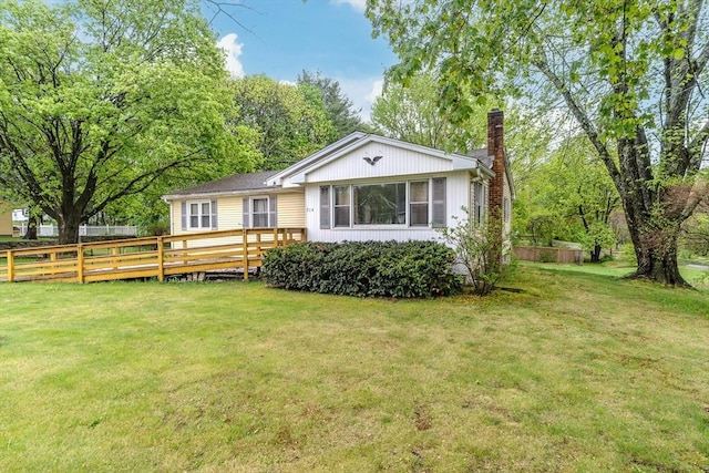 view of front of house featuring a chimney and a deck