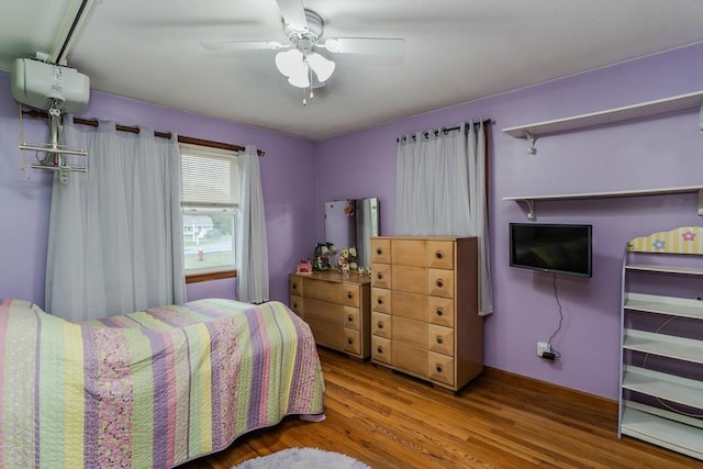 bedroom with wood finished floors and a ceiling fan