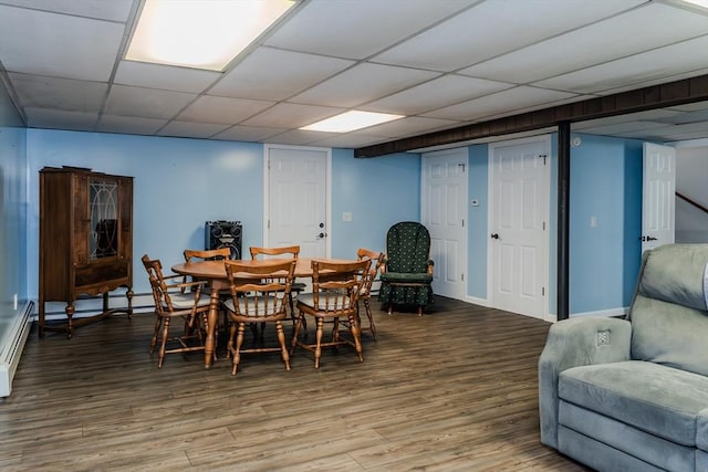 dining area featuring wood finished floors and baseboards
