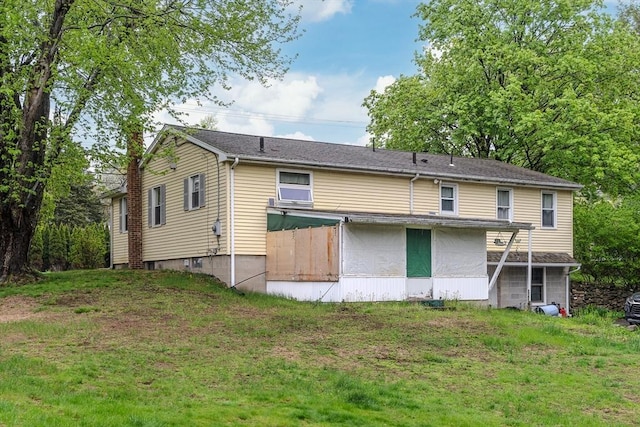 back of property featuring a lawn