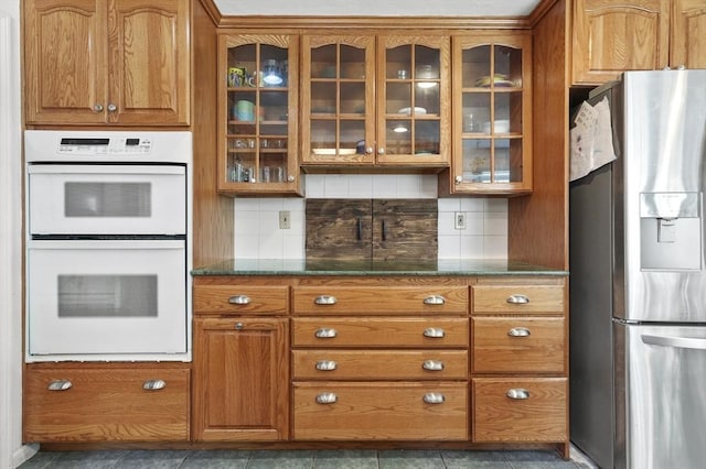 25 Cardigan Rd, Tewksbury, MA 01876 - kitchen featuring stainless steel refrigerator with ice dispenser, double oven, brown cabinets, and glass insert cabinets