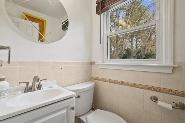 25 Cardigan Rd, Tewksbury, MA 01876 - bathroom with toilet, tile walls, vanity, and wainscoting