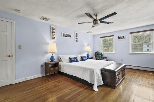 25 Cardigan Rd, Tewksbury, MA 01876 - bedroom with a baseboard radiator, wood finished floors, ceiling fan, and baseboards