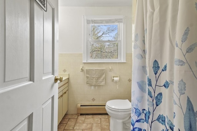 25 Cardigan Rd, Tewksbury, MA 01876 - full bathroom with baseboard heating, toilet, tile walls, vanity, and a shower with shower curtain