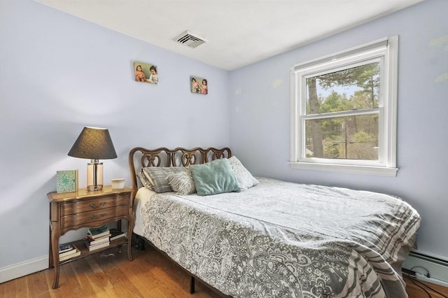 25 Cardigan Rd, Tewksbury, MA 01876 - bedroom with a baseboard radiator, wood finished floors, and baseboards