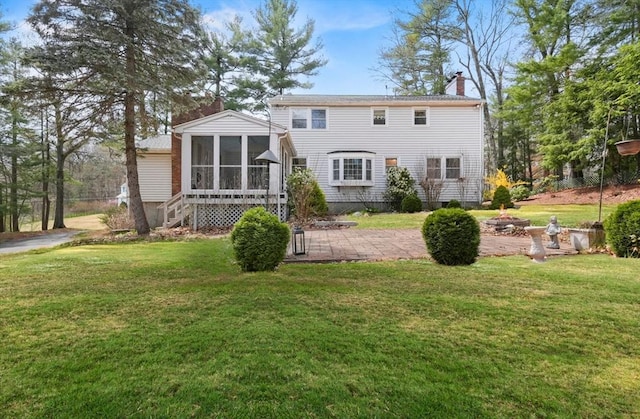 25 Cardigan Rd, Tewksbury, MA 01876 - back of property featuring a chimney, a sunroom, a lawn, and a patio