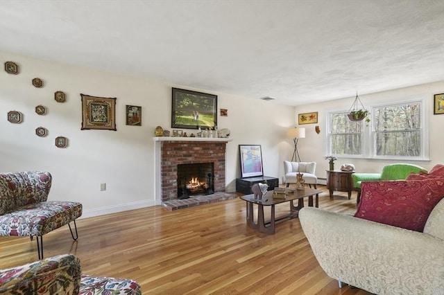 25 Cardigan Rd, Tewksbury, MA 01876 - living area with wood finished floors, a fireplace, and baseboards