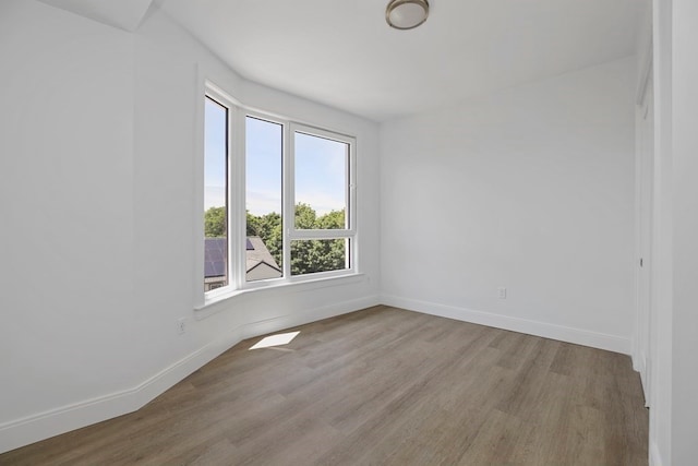 unfurnished room with light hardwood / wood-style floors