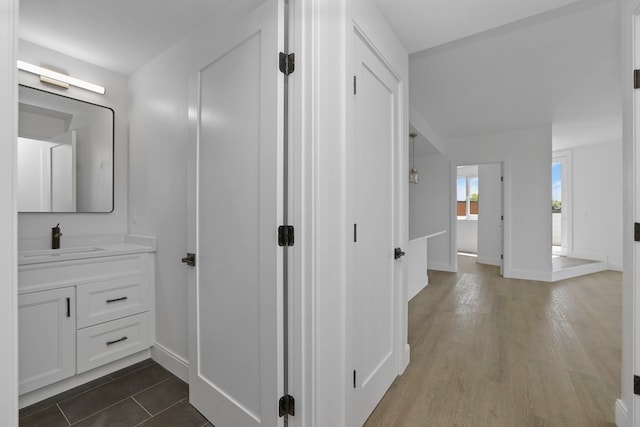 hallway featuring dark hardwood / wood-style flooring and sink