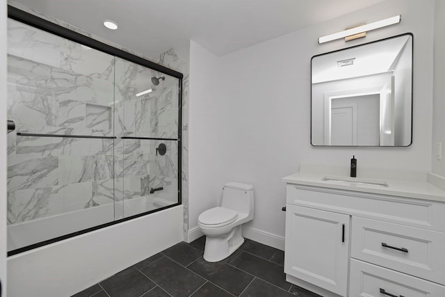 full bathroom with bath / shower combo with glass door, vanity, tile patterned flooring, and toilet