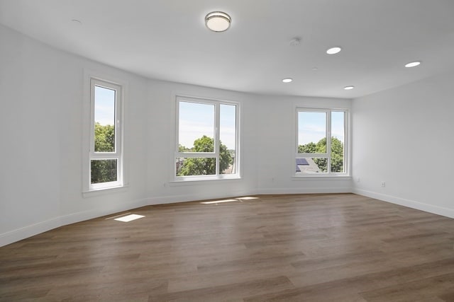 unfurnished room with hardwood / wood-style flooring