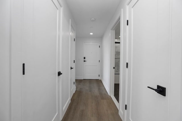 hallway with hardwood / wood-style floors