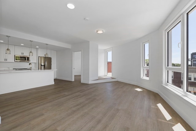 unfurnished living room featuring hardwood / wood-style flooring