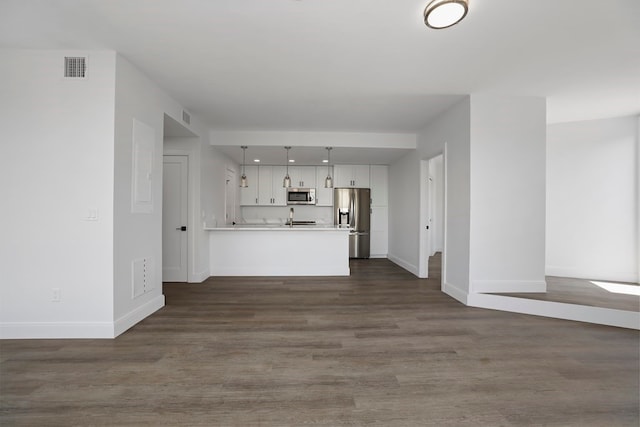 unfurnished living room featuring dark hardwood / wood-style flooring