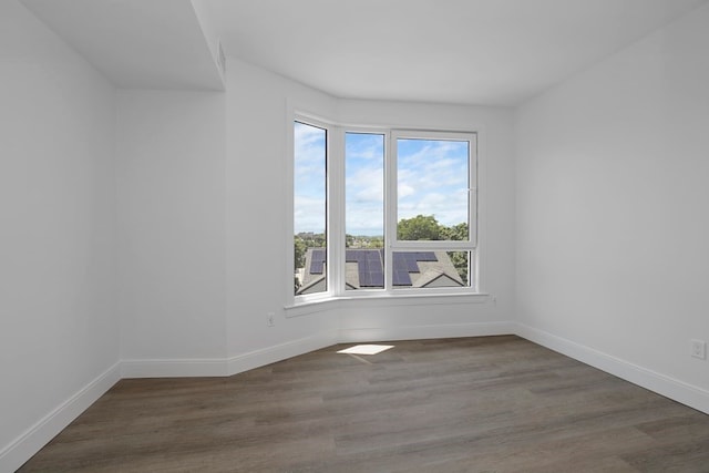 unfurnished room with dark hardwood / wood-style floors