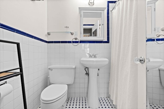 17 Bowdoin Unit 2B, Boston, MA 02114 - full bathroom featuring tile walls, toilet, a shower stall, and a wainscoted wall