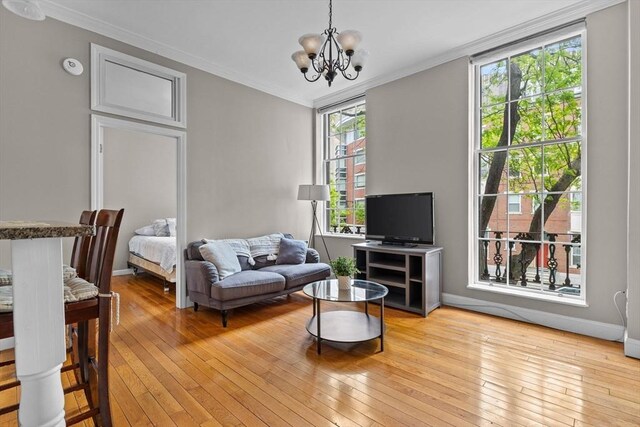 17 Bowdoin Unit 2B, Boston, MA 02114 - living room with light wood-type flooring, a chandelier, crown molding, and baseboards