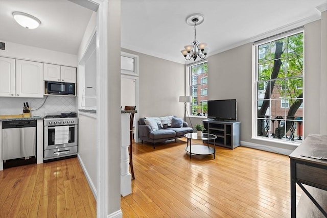 17 Bowdoin Unit 2B, Boston, MA 02114 - kitchen with stainless steel appliances, white cabinets, light wood-style floors, decorative backsplash, and a chandelier