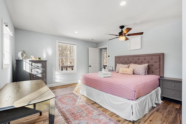 bedroom with ceiling fan and hardwood / wood-style floors