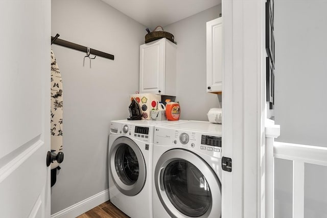 washroom with independent washer and dryer, cabinets, and dark hardwood / wood-style flooring