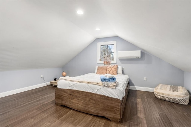 bedroom with dark hardwood / wood-style floors, a wall unit AC, and lofted ceiling