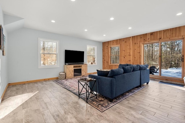 living room featuring wooden walls and light hardwood / wood-style flooring