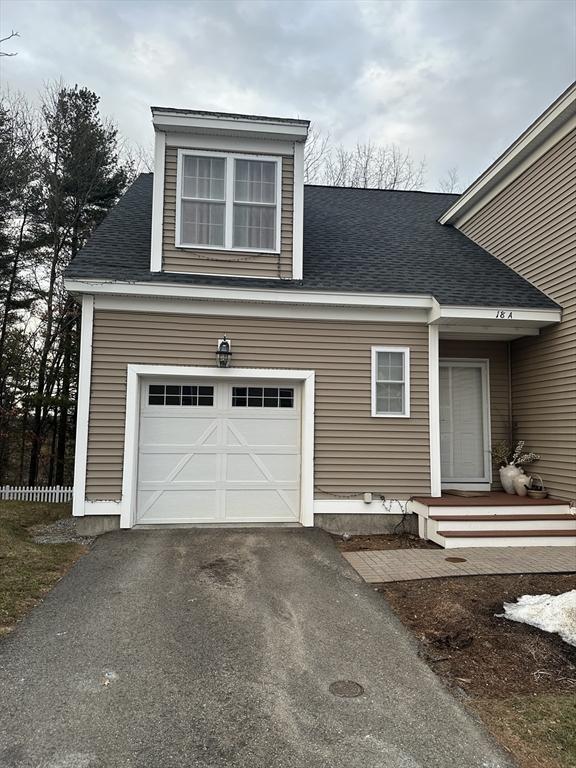 view of front of house with driveway and roof with shingles