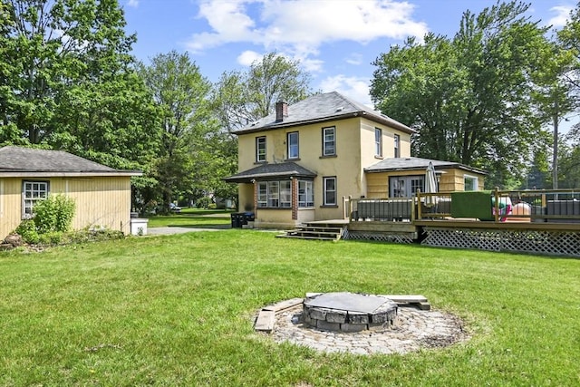 12 Boison St, Pittsfield, MA 01201 - rear view of property featuring an outdoor fire pit, stucco siding, a wooden deck, and a lawn
