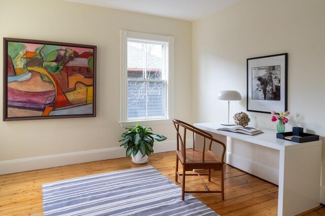 office area featuring baseboards and wood finished floors